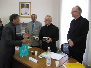 Oman Delegate Offering a gift to  His Eminence whilst H E Archbishop Celata looks on